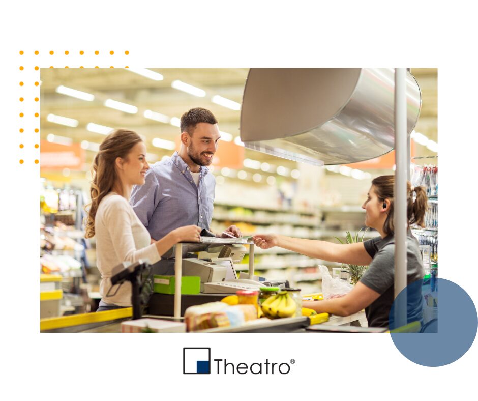 man and woman checking out at grocery store cash register, employee scanning food