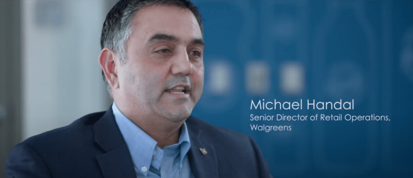 a screenshot of michael handal, a middle aged caucasian Senior Director of Operation at Walgreens in a business suit