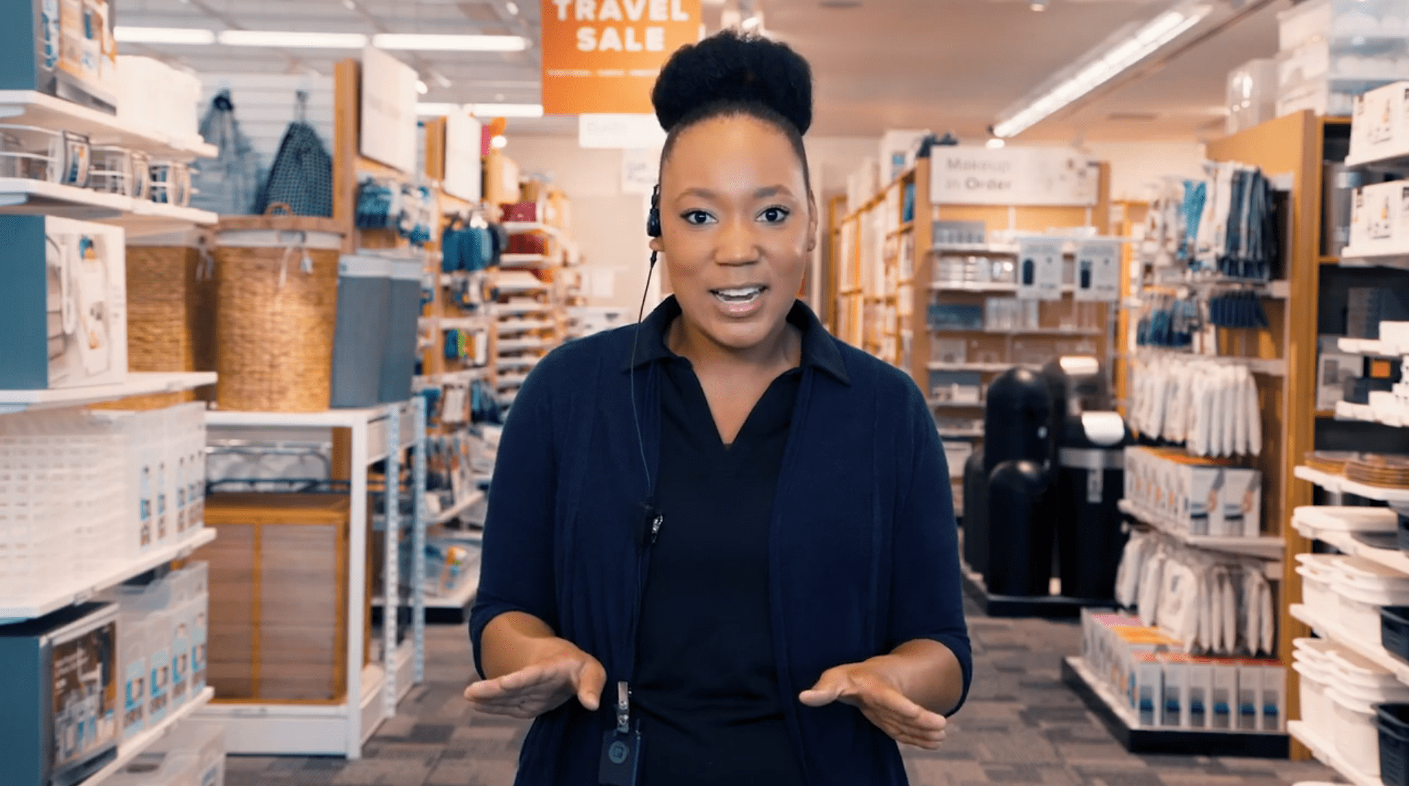 a retail employee looking at camera, wearing theatro device