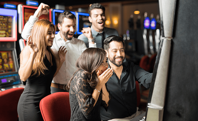 group of friends winning at slot machine