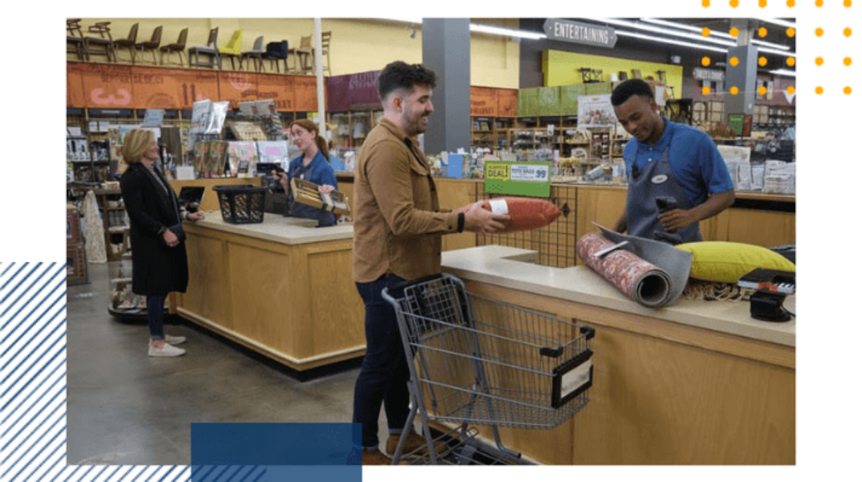 2 employees are checking 2 lines out at a register
