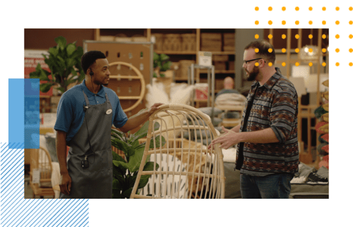 an employee is helping a customer with a question about lawn furniture