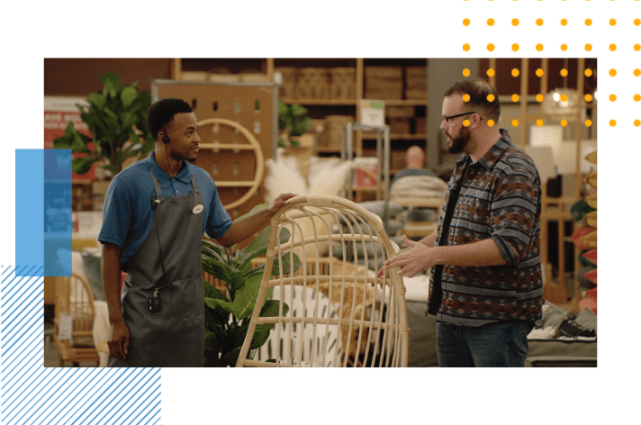 an employee is helping a customer with a question about lawn furniture
