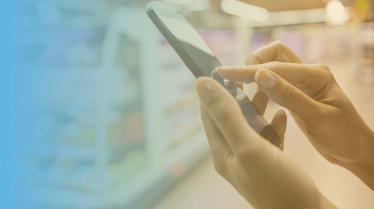 a view of a hand holding a phone in a retail store, and the other hand is touching the screen