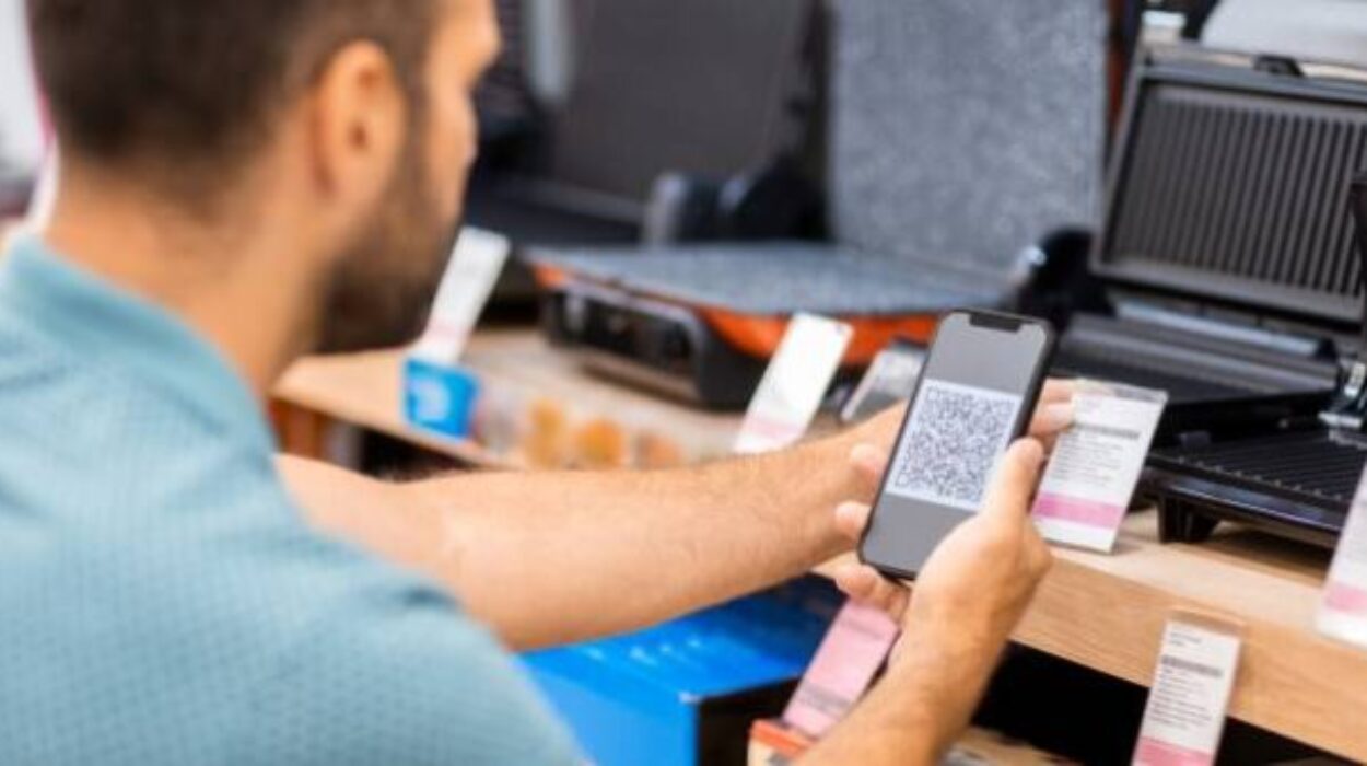 a male customer is scanning a QR code on indoor grill products