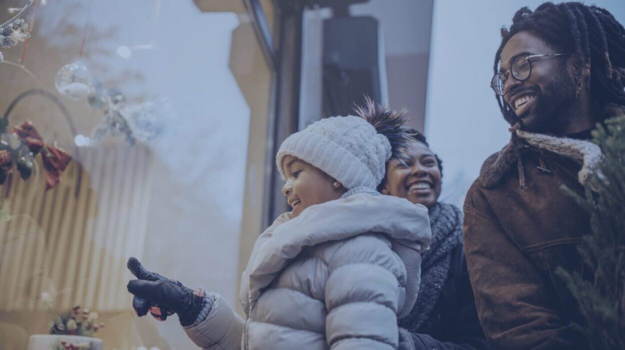 an african-american family window shopping and smiling while father is holding a christmas tree Theatro 2024 Holiday Shopping Report