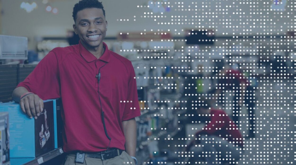 "Smiling retail associate wearing a headset powered by TheatroIQ, demonstrating the seamless in-ear communication and real-time support offered by Theatro’s innovative platform.
