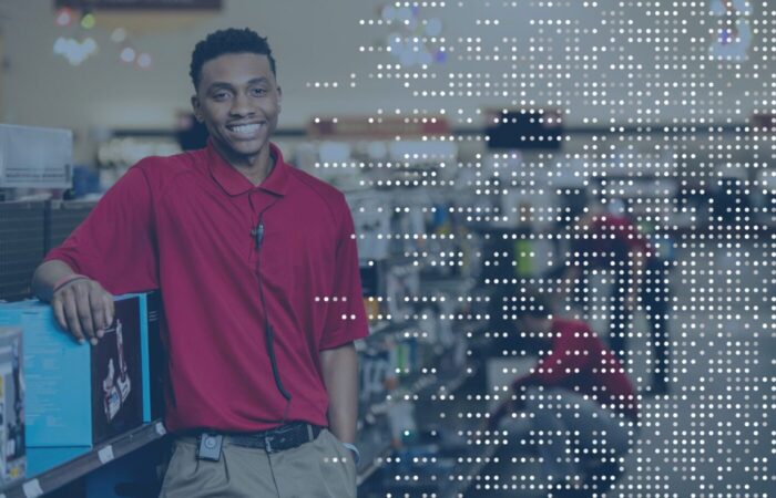 "Smiling retail associate wearing a headset powered by TheatroIQ, demonstrating the seamless in-ear communication and real-time support offered by Theatro’s innovative platform.