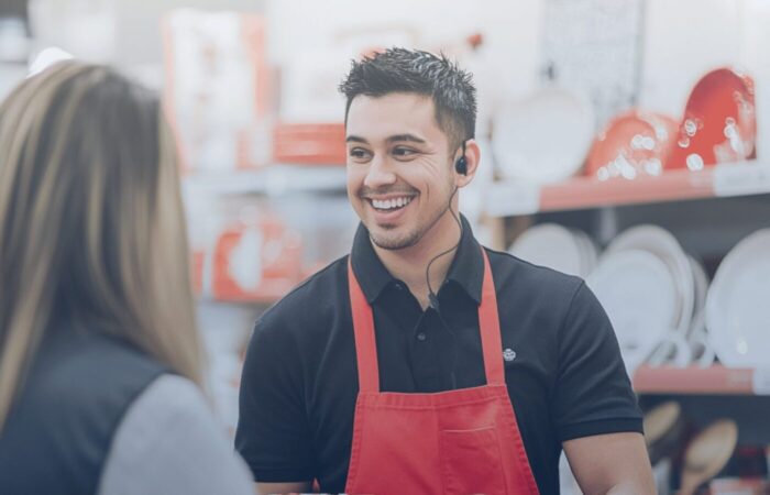 Retail associate smiling while assisting a customer, showcasing the impact of implementing GenAI for retail