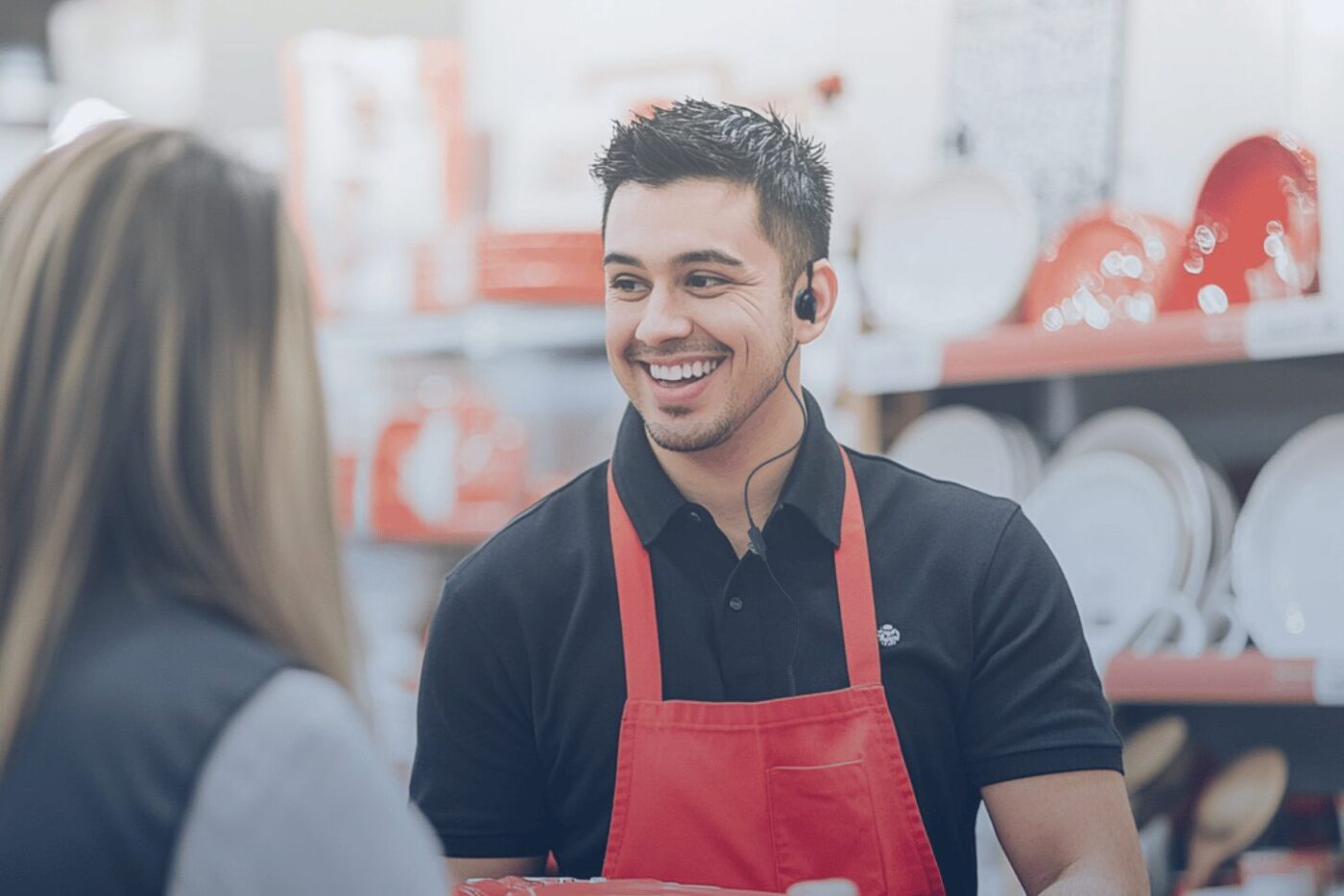Retail associate smiling while assisting a customer, showcasing the impact of implementing GenAI for retail